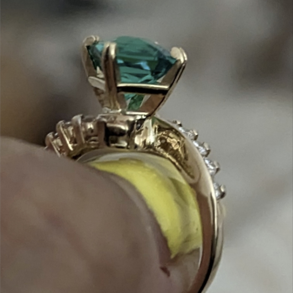 14k real gold and diamonds the emerald is lab created